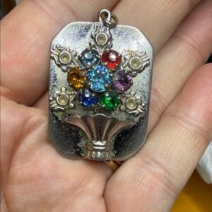 Vintage Pendant with floral arrangements and different stone colors.